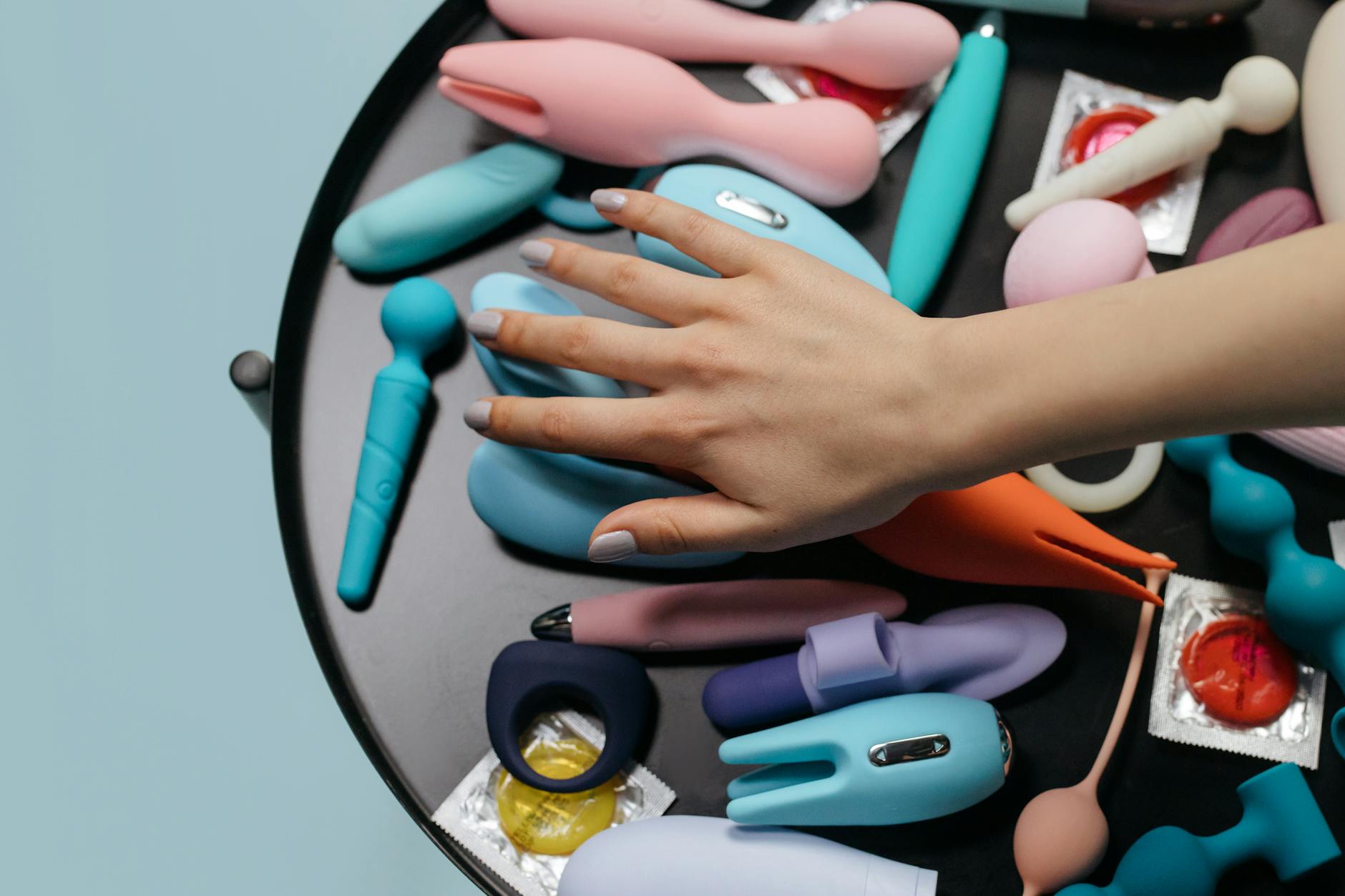 A couple standing together indoors, about to explore intimacy with modern toys