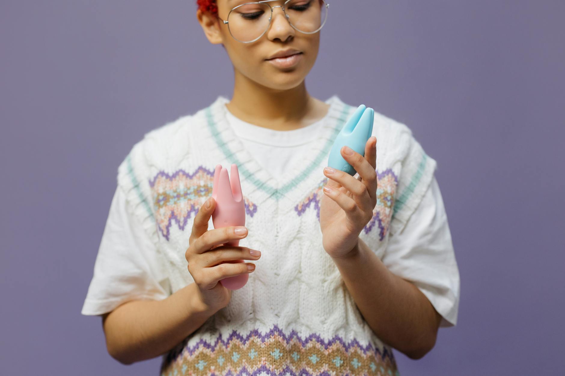 A person holding blue silicone vibrators, demonstrating options for perimenopause pleasure.